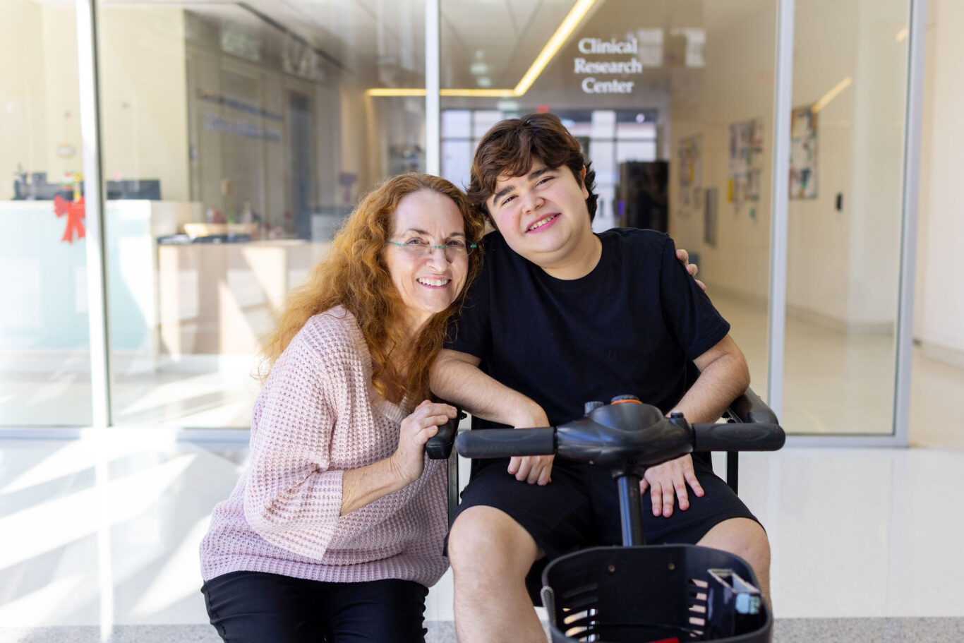 Dr. Claudia Senesac (left) and boy with Duchenne muscular dystrophy (right)